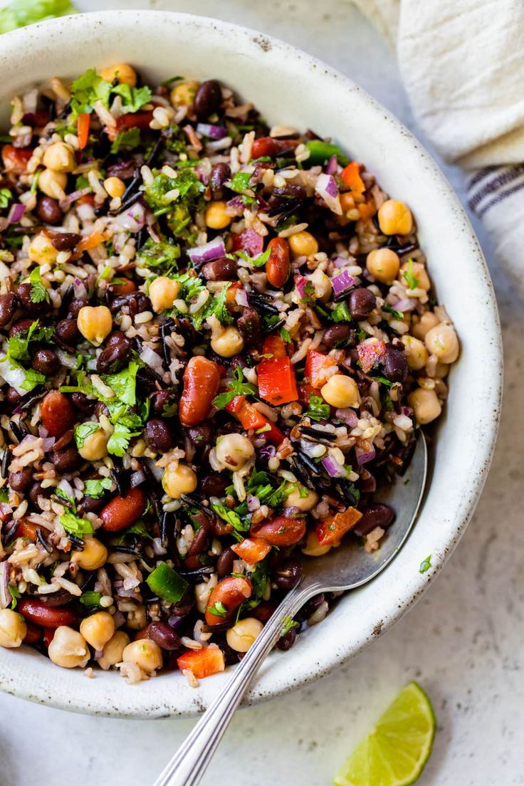 a white bowl filled with black beans and vegetables