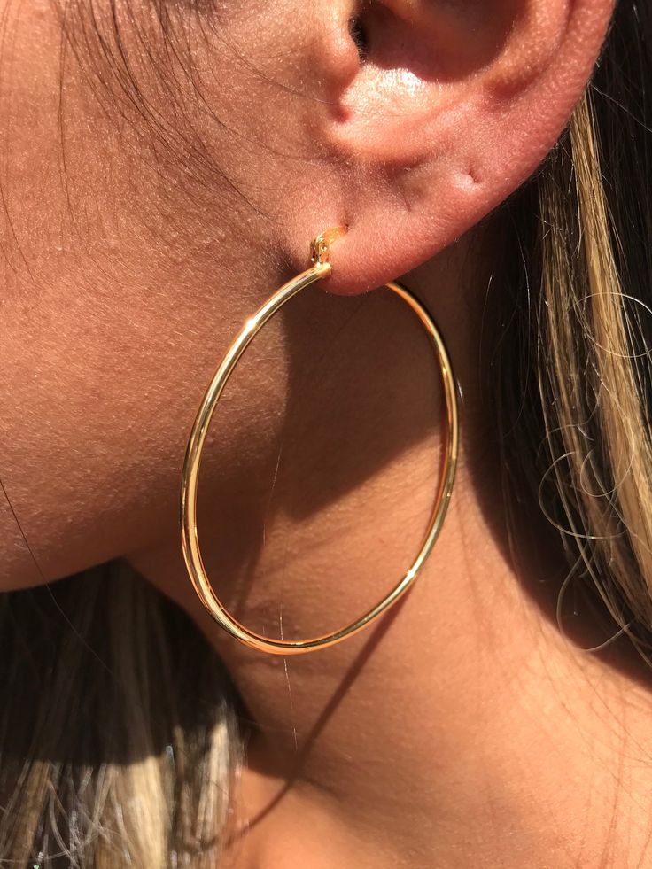 18kt Gold Filled Large Ridged Hoop Earrings Hoop Size: 60mm Width: 2mm Clasp: Hinged Material: 18 Karat Gold Filled, Hypoallergenic. Tarnish Resistant. Gold-filled does not de-laminate or peel like Gold plated Jewelry nor does it tarnish as readily as silver. Generally speaking, gold filled is better quality and will have a much longer lasting color than plated jewelry. We recommend keeping abrasive chemicals away from the jewelry for the items to last. Thank you for visiting and supporting our Hoops Earrings Big, Gold Hoops Large, Large Hoop Earrings Aesthetic, Hops Earrings Gold, Gold Hope Earrings, Golden Hoops Earrings, Gold Hoops Aesthetic, Gold Hoop Earrings Aesthetic, Big Hoops Earrings