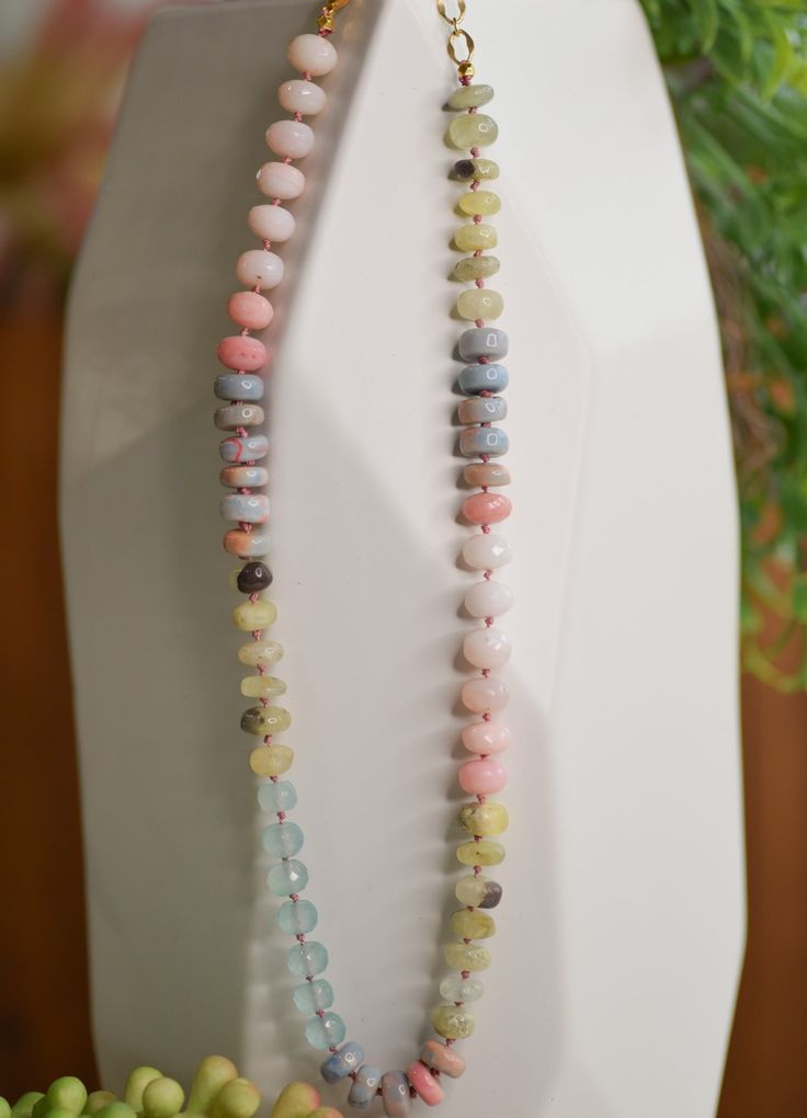 Product Description: Our Java necklace stands out with its petite silk knots between each semi-precious stone, giving it a lush, extravagant drape. Every piece is hand-crafted with love and will be slightly unique, though the colors remain true. Product Details: Genuine mixed pink opal with turquoise and golden moonstone Necklace length: 18"-20" with adjustments Lobster clasp Pearl And Stone Necklace, Knotted Gemstone Necklace, Multicolor Artisan Hand Knotted Jewelry, Pink Gemstone Beads Long Necklace, Pink Long Necklace With Gemstone Beads, Handmade Multicolor Amazonite Beaded Necklaces, Handmade Multicolor Amazonite Beaded Necklace, Artisan Pink Necklace With Colorful Beads, Multicolor Amazonite Jewelry With Gemstone Beads