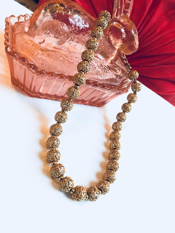 "Fantastic Mid Century Monet Goldtone Open Work Filigree Beaded Choker Necklace A beautiful vintage necklace. It measures approximately 17\" long. It is in excellent condition. It is signed Monet. A wonderful signed quality addition or beginning to any vintage jewelry collection. Beautiful necklace- a stunning gift idea ❤️ www.mysoulrepair.com" Vintage Polished Gold Beads, Vintage Gold Polished Beads, Antique Gold Beaded Necklaces With Large Beads, Antique Filigree Necklaces For Festive Occasions, Antique Gold Necklace With Large Beads, Vintage Large Gold Beads, Antique Beaded Gold Necklaces, Vintage Beaded Chain Necklace With Round Beads, Vintage Gold Beaded Necklaces For Wedding