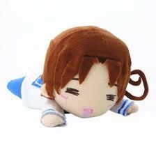 a stuffed animal doll with brown hair and blue eyes laying on the ground next to it's head