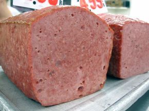 two large slices of meat sitting on top of a cutting board next to each other