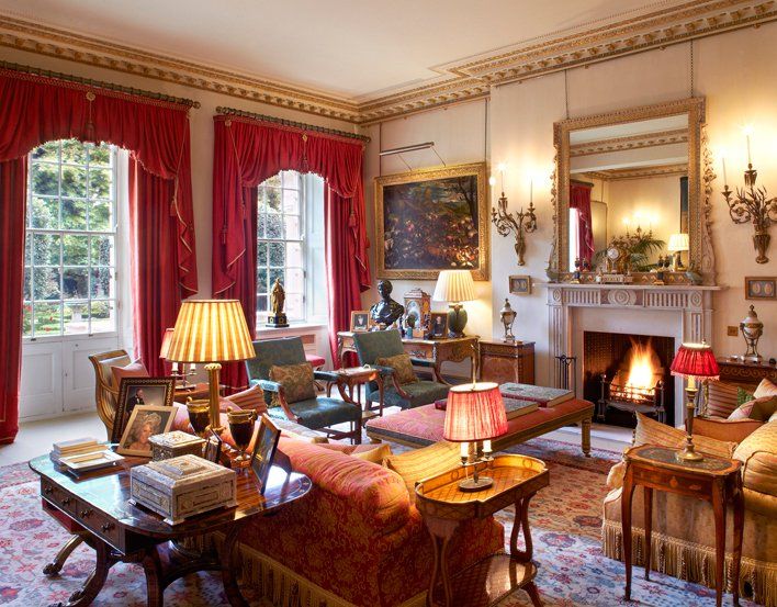 a living room filled with lots of furniture next to a fire place in a fireplace