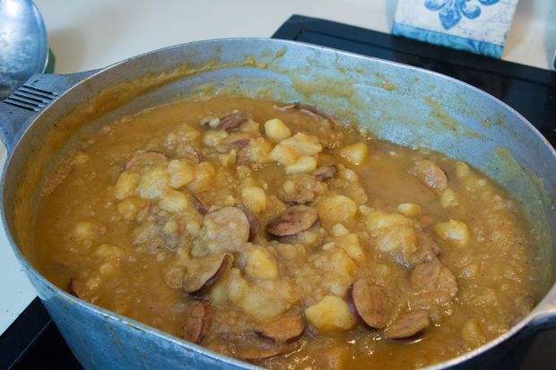 a pan filled with food sitting on top of a stove