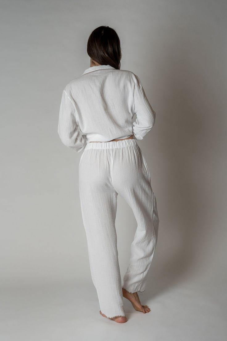 FINAL SALE Made with 100% organic combed cotton, the Alaia Pajama Set is stylish, comfy, and sustainable, making them the perfect addition to any sleepwear collection. With a unique scalloped trim for a touch of sophistication. Relaxed silhouette top Button front Scalloped edges at wrists and ankles One chest pocket Drawstring waist Organic Gauze Kristen is 5'9" and is wearing a size S/MSizes S/M and L/XL. See size guide for sizing recommendations. Solid Cotton Sleepwear For Lounging, Cotton Solid Color Sleepwear For Relaxation, Solid Color Cotton Sleepwear For Relaxation, Solid Cotton Sets For Relaxation, Spring Sets With Relaxed Fit, Cotton Sleepwear For Loungewear, Solid Cotton Sleepwear With Elastic Waistband, White Relaxed Fit Loungewear Sets, Cotton Sets For Lounging