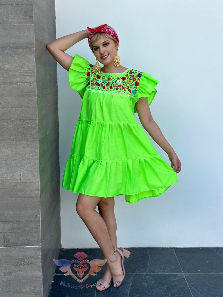 "Neon Green Mexican dress, ruffled sundress, floral embroidery, festival wear, modern boho hippie fashion, fiesta days, all eyes on me, party Introducing our vibrant Neon Green Mexican Dress, a radiant fusion of modern boho hippie fashion and festival flair. This trendy 3-layer ladies' ruffle sundress is your ticket to turning heads and making a statement during fiesta days and festive gatherings. Crafted with meticulous attention to detail, this dress boasts exquisite floral embroidery that adds an artistic touch to the neon green canvas. The ruffled short sleeves and layered design infuse playfulness and elegance into the outfit, creating a perfect blend of bohemian and chic. Whether you're dancing the night away at a festival, sipping margaritas at a beachside party, or simply seeking t Bohemian Beach Mini Dress With Ruffle Hem, Bohemian Ruffle Hem Mini Dress For Beach, Bohemian Mini Dress With Ruffle Hem For Beach, Summer Floral Print Mini Embroidered Dress, Bohemian Mini Dress For Garden Party In Spring, Bohemian Mini Dress For Spring Garden Party, Floral Embroidered Mini Dress For Summer, Bohemian Mini Dress With Ruffle Hem, Multicolor Embroidered Mini Dress For Spring