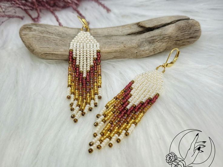 Immerse yourself in handcrafted elegance with our Lexie earring, carefully crafted for those who value originality and authenticity. Unlike mass-produced jewelry, each piece is handcrafted using high-quality stainless steel and seed beads. This earring is perfect for boho fashion lovers looking to express their individuality through unique and meaningful pieces. --- Embrace artisanal elegance with our fringe earring, meticulously crafted for those who value originality and authenticity. Unlike m Unique Round Bead Earrings As Gift, Unique Round Beads Earrings For Gift, Artisan Earrings With Dangling Beads, Bohemian Style White Single Earring, Artisan Beaded Drop Earrings For Gifts, White Artisan Earrings For Pierced Ears, White Artisan Jewelry Nickel Free, Artisan Dangle Beaded Earrings As Gift, Artisan Beaded Dangle Earrings As Gift