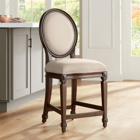 a dining room chair sitting on top of a hard wood floor next to a counter