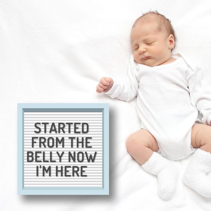 a baby is sleeping next to a sign that says, started from the belly now i'm here