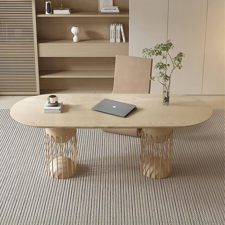 a table with a laptop on it in front of a bookshelf and shelves