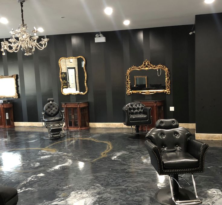 a salon with chairs, mirrors and chandeliers