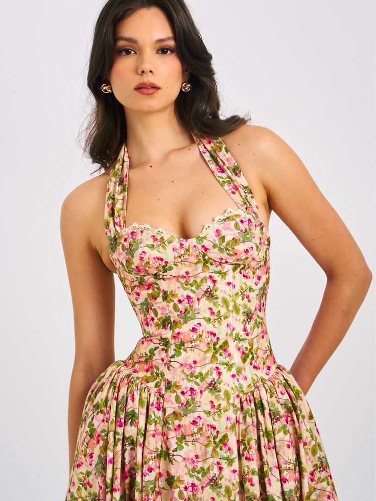 Behold our Niya maxi dress, a stunning union of style and ease. Delicately crafted from a charming floral print fabric, it exudes feminine allure with every step. The drop waist design imparts a contemporary silhouette, while padded cups ensure a flattering fit. Practicality meets elegance with convenient pockets discreetly integrated into the design. Structured with built-in bones and hard mesh supporting the hemline, it promises both form and function. Seamlessly finished with an invisible zip Floral Print Midi Dress With Fitted Bodice, Fitted Midi Floral Dress For Garden Party, Feminine Fitted Bodice Maxi Dress For Summer, Floral Print Dresses With Sweetheart Neckline And Fitted Bodice, Daywear Dresses With Floral Print And Fitted Bodice, Feminine Fitted Bodice Dress For Garden Party, Feminine Dresses With Fitted Bodice For Garden Party, Spring Floral Print Maxi Dress With Fitted Bodice, Floral Print Fitted Bodice Sundress