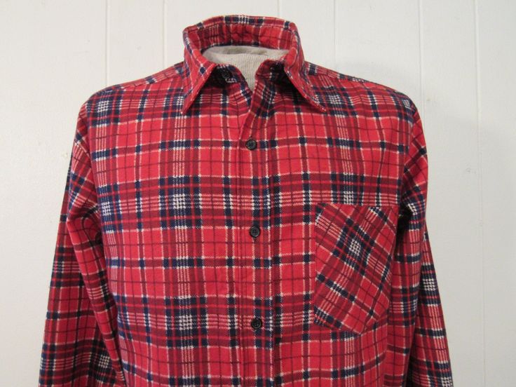 "Vintage 1970s shirt. Made of blue and red plaid cotton flannel. Features a button front, chest pocket and button cuffs. Label is missing. Size large. Actual measurements are: 45\" around the chest, 44\" at the waist, 19\" shoulder seam to shoulder seam, 24\" shoulder seam to end of cuff, 30\" overall length. In excellent unused condition. New old stock." Red Flannel Shirt With Buttons, Red Flannel Collared Shirt, Vintage Plaid Shirt With Pockets, Plaid Cotton Flannel Shirt With Placket, Vintage Plaid Flannel Shirt With Button Closure, Vintage Red Flannel Shirt With Button Closure, Retro Plaid Flannel Shirt With Buttons, Vintage Red Flannel Shirt, Red Vintage Flannel Shirt With Button Closure