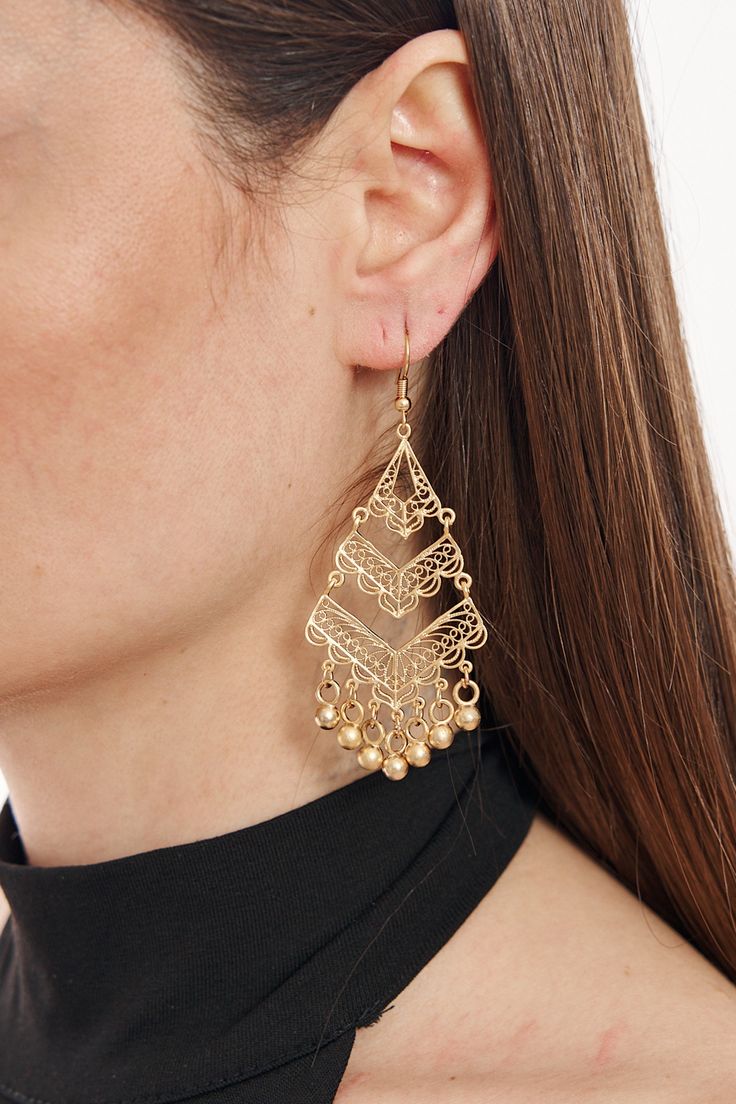 Elevate your accessory game with these captivating statement earrings. Made with top-quality gold-plated brass, these earrings exude a luxurious appeal. The intricate design, complemented by dainty bead accents, showcases exquisite craftsmanship, making it perfect for special occasions or everyday wear. Its chunky yet elegant style is sure to draw compliments and be a conversation starter. Whether paired with a chic dress or casual outfit, these earrings are a testament to timeless beauty and sophisticated design. Metal Tassel Drop Earrings For Pierced Ears, Gold-tone Dangle Earrings For Pierced Ears, Gold Dangling Bead Jewelry, Gold Dangling Bead Earrings, Gold Beaded Drop Earrings, Gold Dangle Jewelry With Beads, Gold Dangle Jewelry With Dangling Beads, Gold Bohemian Tassel Earrings For Festive Occasions, Gold-tone Metal Chandelier Earrings