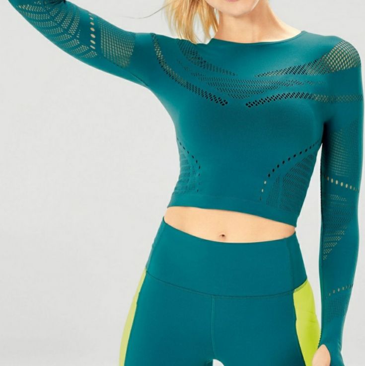 Say Hello To A Top That's Sporty Enough To Withstand Your Studio Class And Sexy Enough To Wear To The Bar. Oh And Its Soft, Yet Compressive Seamless Fabric, Supreme Breathability And Sweat-Wicking Abilities. Seamless Long Sleeve Athleisure Tops, Seamless Long Sleeve Workout Tops, Sporty Long Sleeve Seamless Top, Green Stretch Tops For Pilates, Stretchy Green Tops For Pilates, Trendy Stretch Sports Top, Trendy Stretch Tops For Sports, Green Seamless Yoga Top, Casual Long Sleeve Top With Seamless Construction