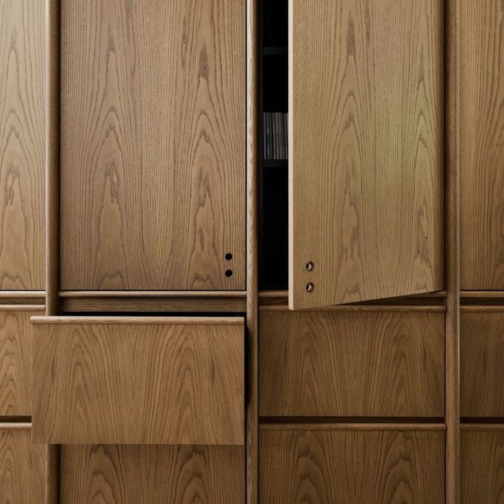 the wooden cabinets are all lined up with doors open to reveal an area that has been made out of wood