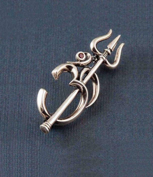 a silver brooch with an anchor on it's end and a red stone in the center