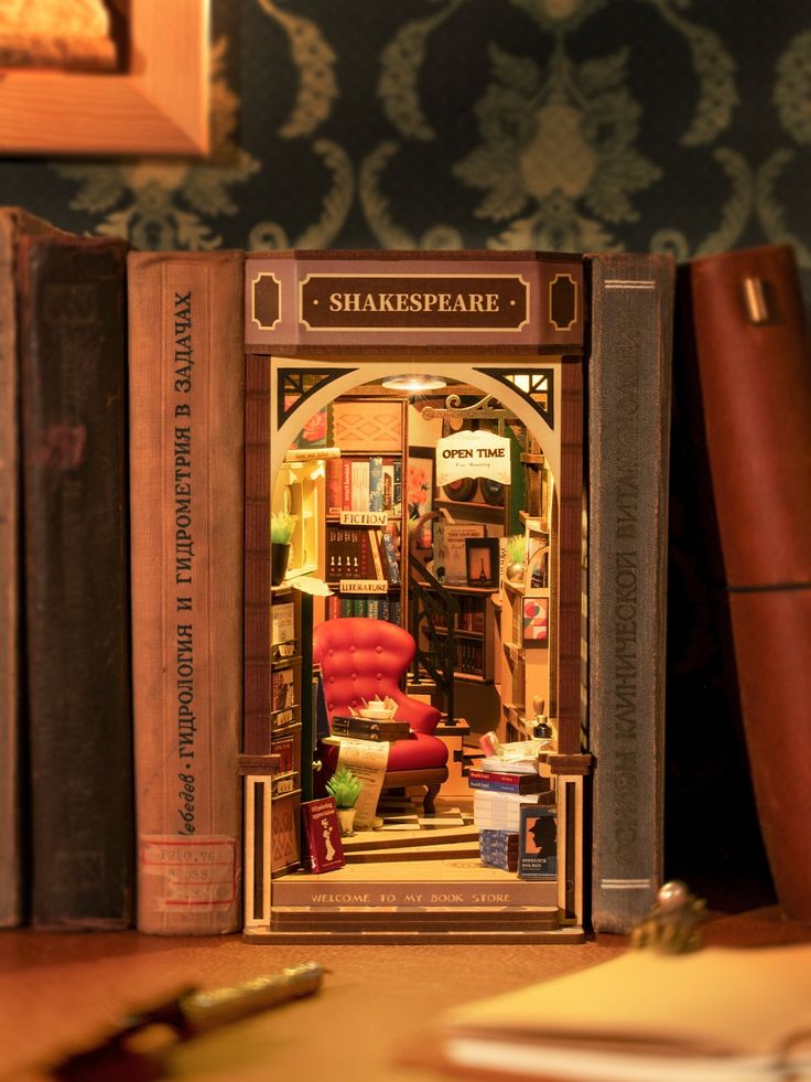 an open book case sitting on top of a wooden table next to bookshelves