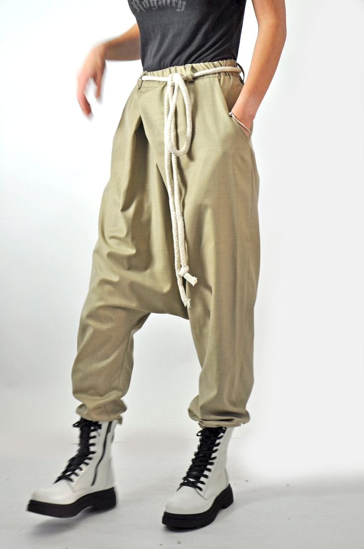 "Harem Pants, Wide Leg Pants, Beige Pants Beige loose soft wool pants,casual extravagant pants. Woman Harem pants. Very comfortable asymmetric loose pants. This pants is very convenient for your daily life. All my clothes are unique and boutique. Each model was conceived and comply with fabric and color according to the season and the fashion line. Model size: SIZE S (US 6, UK 10, Italian 40, French 38, German 36, Japan 7) bust: fits bust around 35.5\" / 90cm Waist: fits waist around 28\"/ 71cm Baggy Wide Leg Khaki Bottoms, Baggy High-waisted Khaki Harem Pants, Baggy Harem Pants With Hip Pockets, High-waisted Khaki Harem Pants With Elastic Waistband, Khaki Straight Pants With Loosely Fitted Hips, Cotton Drop Crotch Pants With Elastic Waistband, Summer Drop Crotch Pants With Pockets, Beige Long Harem Pants With Pockets, Wide Leg Khaki Harem Pants With Pockets