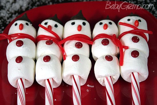 marshmallows are wrapped in red and white candy canes to look like snowmen