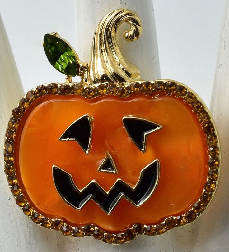 This ring consists of a repurposed  orange pumpkin button Small orange rhinestones add sparkle. It measures approximately 1 1/4'. It will fit any finger as it is attached to an adjustable gold-plated ring band. Pumpkin Ring, Orange Pumpkin, Plated Ring, Gold Plated Rings, Pumpkin Orange, Ring Band, Halloween Pumpkin, Adjustable Ring, Jack O Lantern