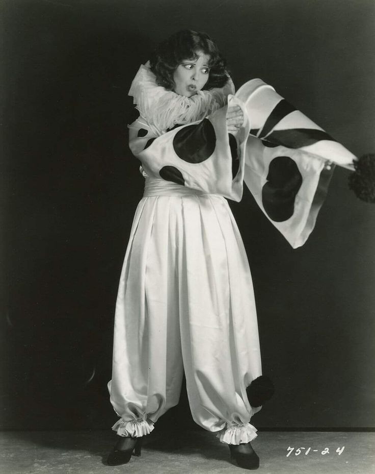 an old photo of a woman dressed in costume