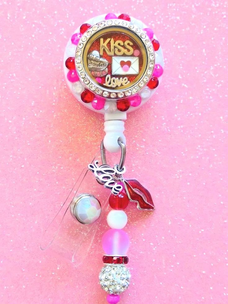 Floating locket collection! This is a cute Valentine's day love floating locket badge reel. Comes as shown in picture! All floating locket badges are made with the best Swarovski crystal rhinestones. Badge reel This cute badge reel is handmade and comes with a very cute charm and dangling beads as shown in the pic. Show off your new handmade badge reel to all your co-workers All badge reels come on a slide clip! Alligator swivel clip upon request Charms can vary based on stock but will always be Customizable Red Badge Reel As A Gift, Personalized Cute Badge Reel For Gift, Cute Personalized Badge Reel For Gifts, Personalized Silver Badge Reel For Gift, Personalized Silver Badge Reel Gift, Personalized Silver Badge Reel As Gift, Handmade Novelty Badge Holders For Gifts, Personalized Novelty Badge Reel For Gift, Personalized Pink Badge Holders For Gifts