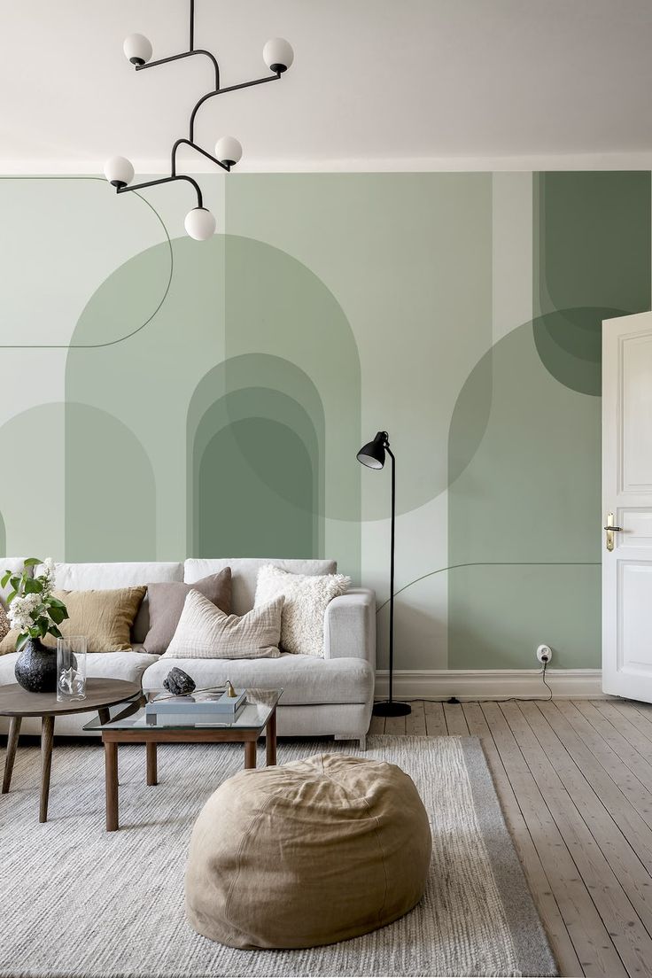 A green abstract arches wallpaper from HappyWall Wallpaper Drawing Room Ideas, It Office Wall Design, Living Room Wallpaper Green, Wallpapers In Living Room, Green Mural Painting, Monochromatic Accent Wall, Living Room Accent Wallpaper, Salon Wall Colors Ideas, Wallpaper Living Room Accent Wall Ideas