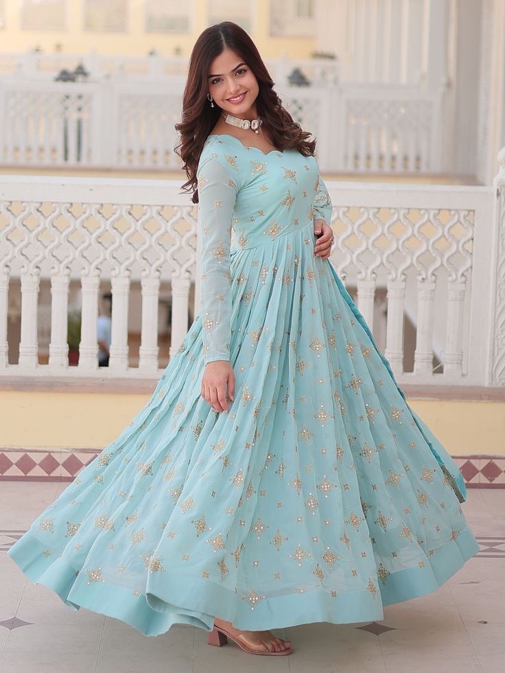 Immerse yourself in elegance with this captivating sky-blue georgette anarkali gown, adorned with exquisite zari embroidery and shimmering sequin work. This gown is designed to make you shine, combining traditional craftsmanship with modern sophistication, making it an ideal choice for engagement ceremonies and other grand occasions. Fully stitched and available in sizes XS to XXL, it ensures a perfect fit for all. The gown features a 3.5-meter flair that adds a graceful flow, while its 56-inch Blue Georgette Maxi Lehenga, Blue Semi-stitched Georgette Gown, Semi-stitched Blue Georgette Gown, Fitted Light Blue Floor-length Anarkali Set, Blue Maxi Gown For Diwali, Blue Georgette Gown For Diwali, Blue Georgette Anarkali Set For Wedding, Festive Anarkali Gown In Light Blue, Light Blue Floor-length Anarkali Set With Dupatta