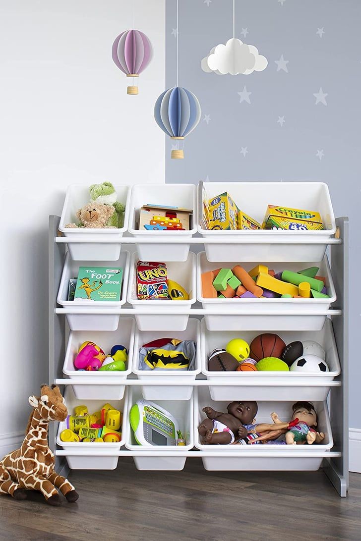 a toy storage unit with toys and other items on it in a child's playroom