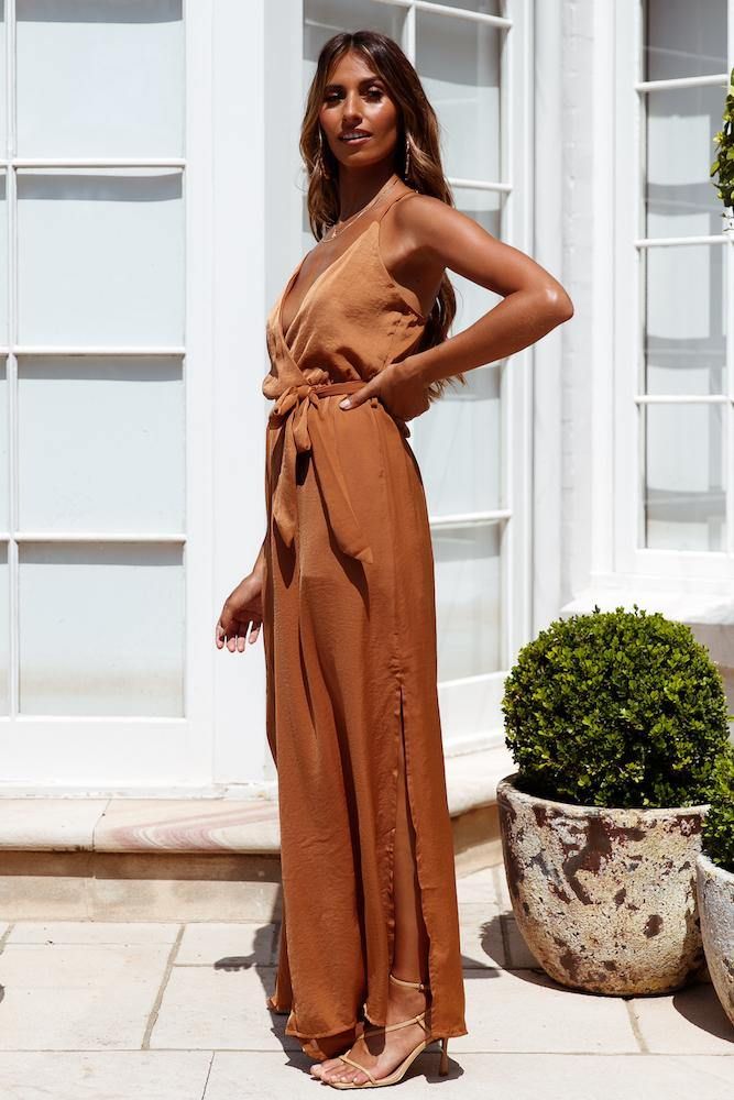 Length: Inside Leg: 76cm; Front Rise: 35cm; Leg Cuff: 218 (of size S). Tan jumpsuit. 鈥≒artially lined. Cold hand wash only. Model is a standard XS and is wearing XS. True to size. Non-stretchy woven satin fabric with sheen. Adjustable shoulder straps. Split back; invisible zipper. Belt-loops; waist tie. Polyester. The epitome of effortless glamour starts with the Raise Your Standards Jumpsuit. As its name suggests, this party essential raises your evening out from a four to an eleven! Combining the classic high-waist silhouette, romantic colours and contemporary design, the jumpsuit features a deep wrap neckline, relaxed pants with split seams and a slit to the rear! Tan Jumpsuit, Zipper Belt, Raise Your Standards, Relax Pants, Romantic Colors, Leg Cuffs, Cold Hands, Invisible Zipper, Waist Tie