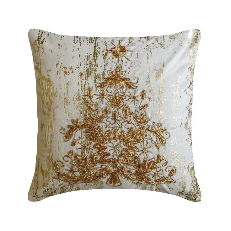 a gold and white decorative pillow on a white background