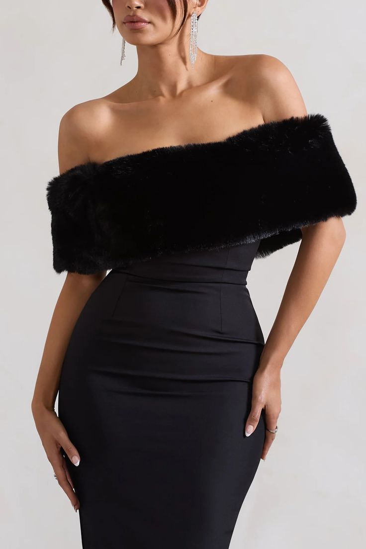 a woman wearing a black dress and fur stole