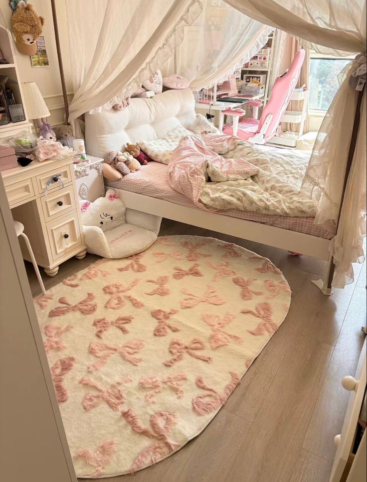 a room with a bed, desk and rug on the floor in front of it