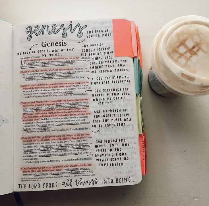 an open bible next to a cup of coffee and a pen with writing on it