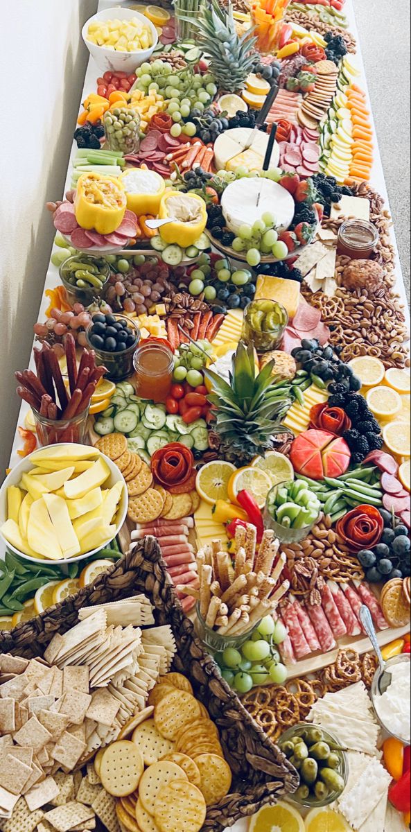 a long table filled with lots of different types of food and snacks on it's sides