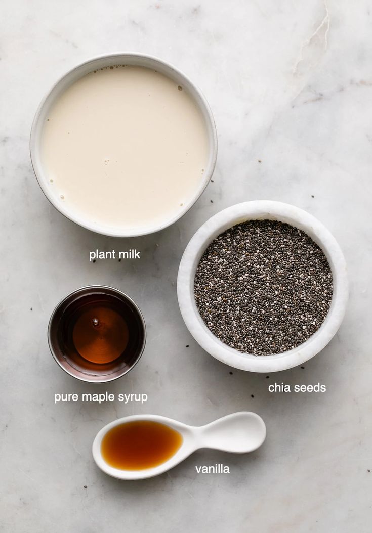 the ingredients to make chia seed pudding are shown in bowls on a marble surface