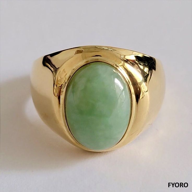 The 'Anyang Royal Spring Jade Ring' symbolizes the ancient Chinese city of Anyang, the birthplace of Chinese civilization 3000 years ago. This beautiful piece symbolizes strength and legacy through its robust and striking design.The Spring Jade is 100% non-dyed, natural Jadeite - straight from mother nature, cut to brilliance by our best Jadeite carvers.  Ring sizes available Specifications vary according to Ring Size. Typical specifications for Size US 10 are shown below (Ring as seen in the im Modern Gold Ring With Large Stone, Modern Gold Rings With Large Stone, Oval Spiritual Ring With Polished Finish, Oval Spiritual Rings With Polished Finish, 14k Gold Ring With Large Stone, Fine Jewelry Gold Jade Rings, Gold Jade Rings In Fine Jewelry Style, Fine Jewelry Gold Rings With Jade, Formal Gold Jade Rings