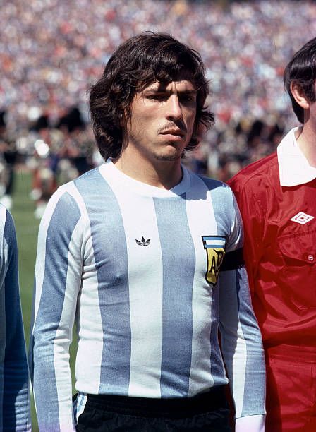 three men standing next to each other in front of a stadium full of people watching