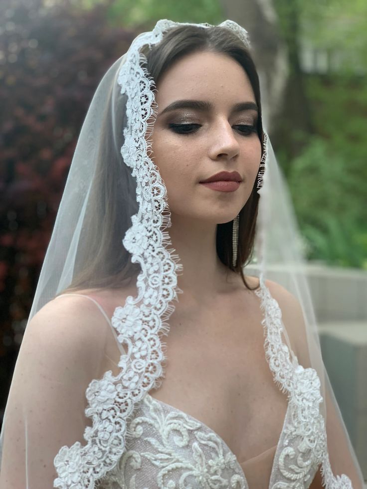 a woman in a wedding dress wearing a veil