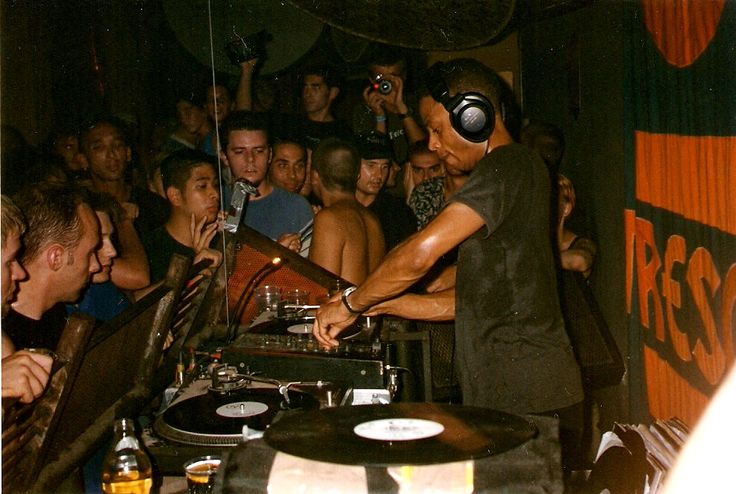 a dj mixing music in front of a crowd