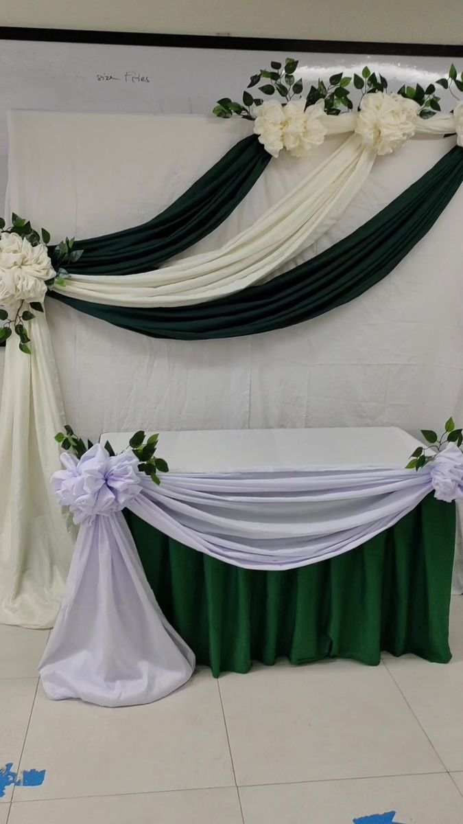 an arrangement of white and green flowers on the back of a chair