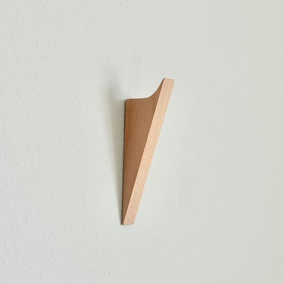 a wooden object hanging on the wall