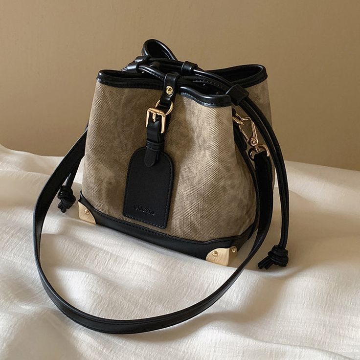 An elegant lingering sound that transcends the times. A bucket bag that can hold your smartphone, wallet, and makeup pouch. The combination of the dark and light body and the jet black leather is exquisite. The decorated leather tag adds a touch of playfulness. You will be fascinated by the delicate details. 
 
 
 Size 
 
 
 FREE size 
 
 Height: 16.5cm 
 Width: 17cm 
 Depth: 11cm 
 
 
 
 
 
 Material 
 
 Leather 
 Rayon Elegant On-the-go Bucket Bag, Luxury Bucket Shape Shoulder Bag As Gift, Luxury Bucket-shape Shoulder Bag As Gift, Luxury Bucket Shape Bag For Gift, Luxury Bucket Bag With Mobile Phone Bag For Everyday, Luxury Bucket Bag With Mobile Phone Holder For Everyday, Trendy Leather Portable Bucket Bag, Portable Leather Crossbody Bucket Bag, Large Capacity Evening Bucket Shoulder Bag