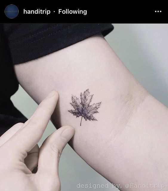 a small leaf tattoo on the left side of the right arm is shown in black and white