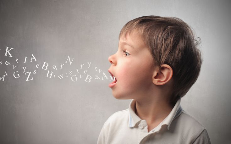 a young boy with his mouth open and words written on the wall behind him that say ways to promote language development