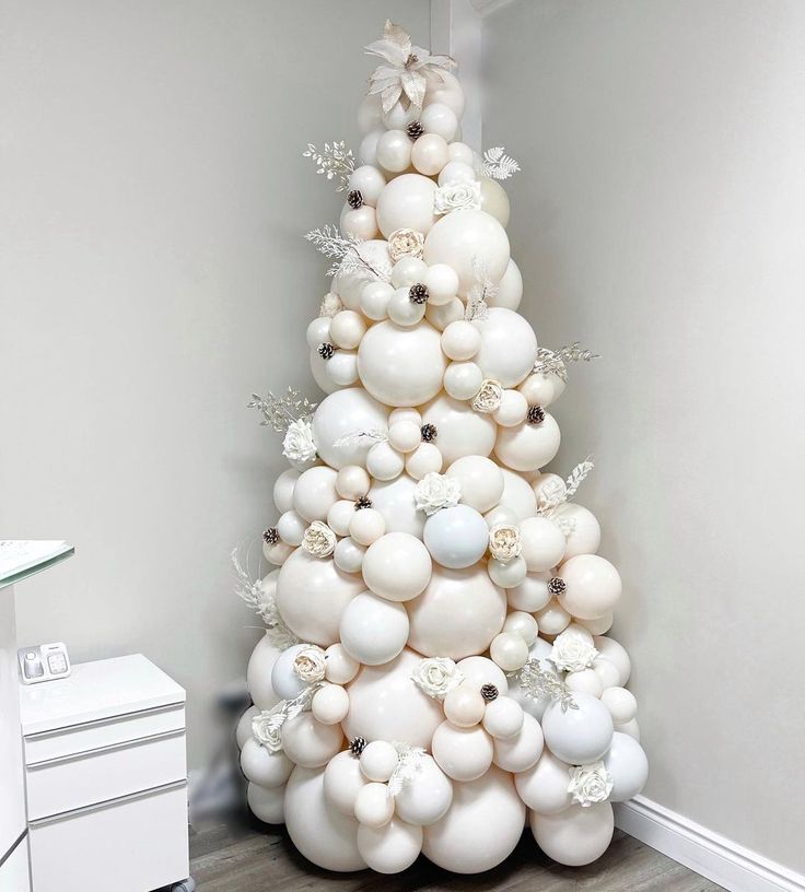 a white christmas tree made out of balloons