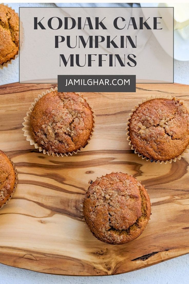 four muffins sitting on top of a wooden cutting board with the words kodak cake pumpkin muffins