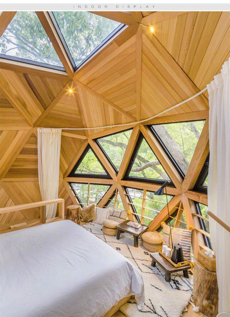 a bedroom with wooden walls and ceiling is shown