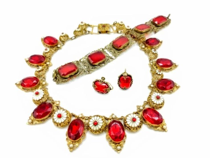 "Necklace, Bracelet & Beautiful Earrings. I am selling one of my long time favorite jewelry items ... Oval Cherry Red Faceted Glass Transparent and set in Brass Oval Setting with small pearl at base of setting, Round white Enamel Floral Design Set on a Brass Filigree Round Metal Discs with Seed Pearl Center. Each red faceted glass and faux pearl link measures 1 1/4\" x 11/16\" and each of the smaller domed links with a white enamel flower form with a central red glass cabochon is 5/8\" across. L Red Costume Jewelry Sets For Formal Occasions, Red Antique Collectible Jewelry, Collectible Red Ruby Jewelry, Red Hallmarked Jewelry For Formal Occasions, Formal Hallmarked Red Jewelry, Elegant Red Jewelry With Cabochon, Elegant Red Cabochon Jewelry, Formal Red Hallmarked Jewelry, Antique Red Gemstone Jewelry